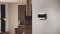 Das Bild zeigt eine Carrier Thermostat an der Wand eines modernen Wohnzimmers.
