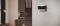 Das Bild zeigt eine Carrier HVAC-Steuereinheit an der Wand eines modernen Wohnzimmers.